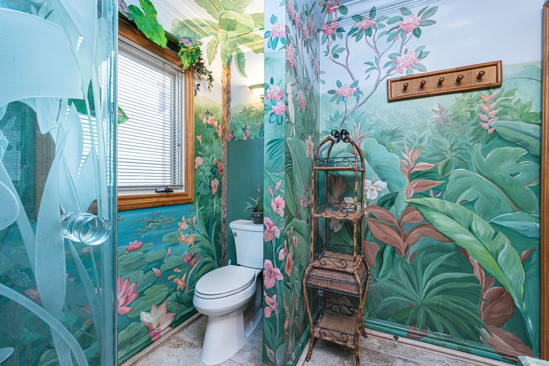 A bathroom with a toilet, a shower, and a shelf with a mirror.