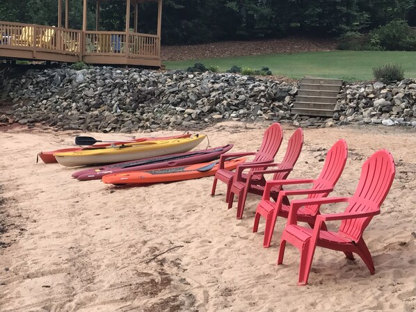 A sandy beach with kayaks and red chairs. - Luxury on Lake Keowee - FALL & Summer 2027 NOW OPEN (Seneca)