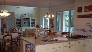 A spacious kitchen with a large island, white cabinetry, and a view of the outdoors. - Luxury on Lake Keowee - FALL & Summer 2027 NOW OPEN (Seneca)