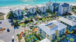 A coastal hotel with multiple buildings, a parking lot, and a beach in the background. - GULF-FRONT, Cancellation, Balcony, Grill, Pool, Updated! (Santa Rosa Beach)