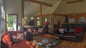 Una sala de estar amplia con chimenea, un comedor y una cocina.