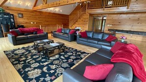 A spacious living room with multiple sofas, a coffee table, and a patterned rug. - Welcome to “Majestic View” – The View of a Lifetime! (Burnside)