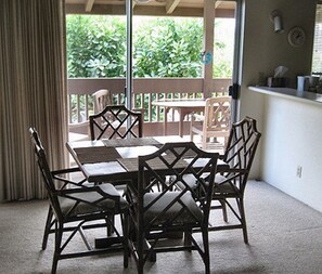 Enjoy meals with family and friends in this dining area, featuring a table for four and comfortable seating.