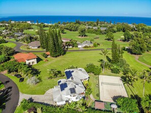 A residential area with houses, a golf course, and a view of the ocean. - Waterfalls, Rainbows, Hot Tub, Golf, Tennis, Pool, Walk to Beach, Volleyball Crt (Princeville)