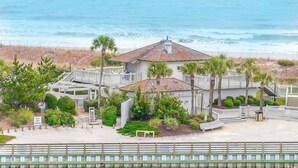 A beachfront property with a large house, a covered patio, and a view of the ocean. - Oceanfront Dream Vacation! 11th Floor-What a View!! + Beach Locker-Book Early! (Myrtle Beach)