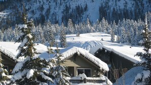 A snow-covered mountain with a lodge in the foreground. - Home Away From Home in Snowcreek V Resort (Mammoth Lakes)