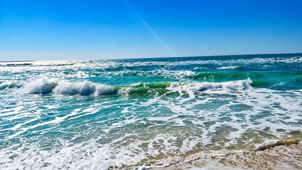 A beach with waves and clear blue sky. -  Coastal Cottage across from the beach, pet friendly, fenced yard (Port Saint Joe)