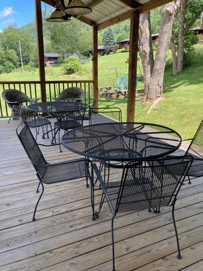 A covered outdoor patio with metal furniture and a view of a green landscape. - Sugar Plum Cabin - Beautiful leaf & Mountain View, Kids Ski FREE, Holiday FUN (Maggie Valley)