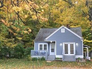 Bay Shore Memories offers a charming single-story retreat with a gabled roof and cozy front porch.