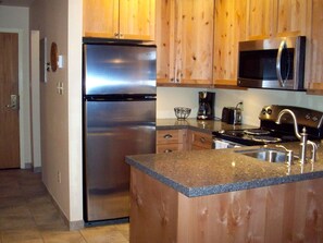 Kitchen area with entrance hallway to the left