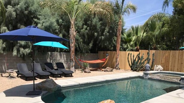 A swimming pool with lounge chairs and a hammock. - BRAND NEW, PRISTINE HAVEN WITH SALT WATER  POOLS (Palm Springs)