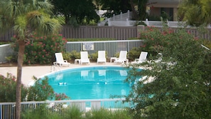 A swimming pool with white lounge chairs and a no lifeguard sign. - Newly Renovated Condo in Beautiful Beach Front Resort (Hilton Head Island)