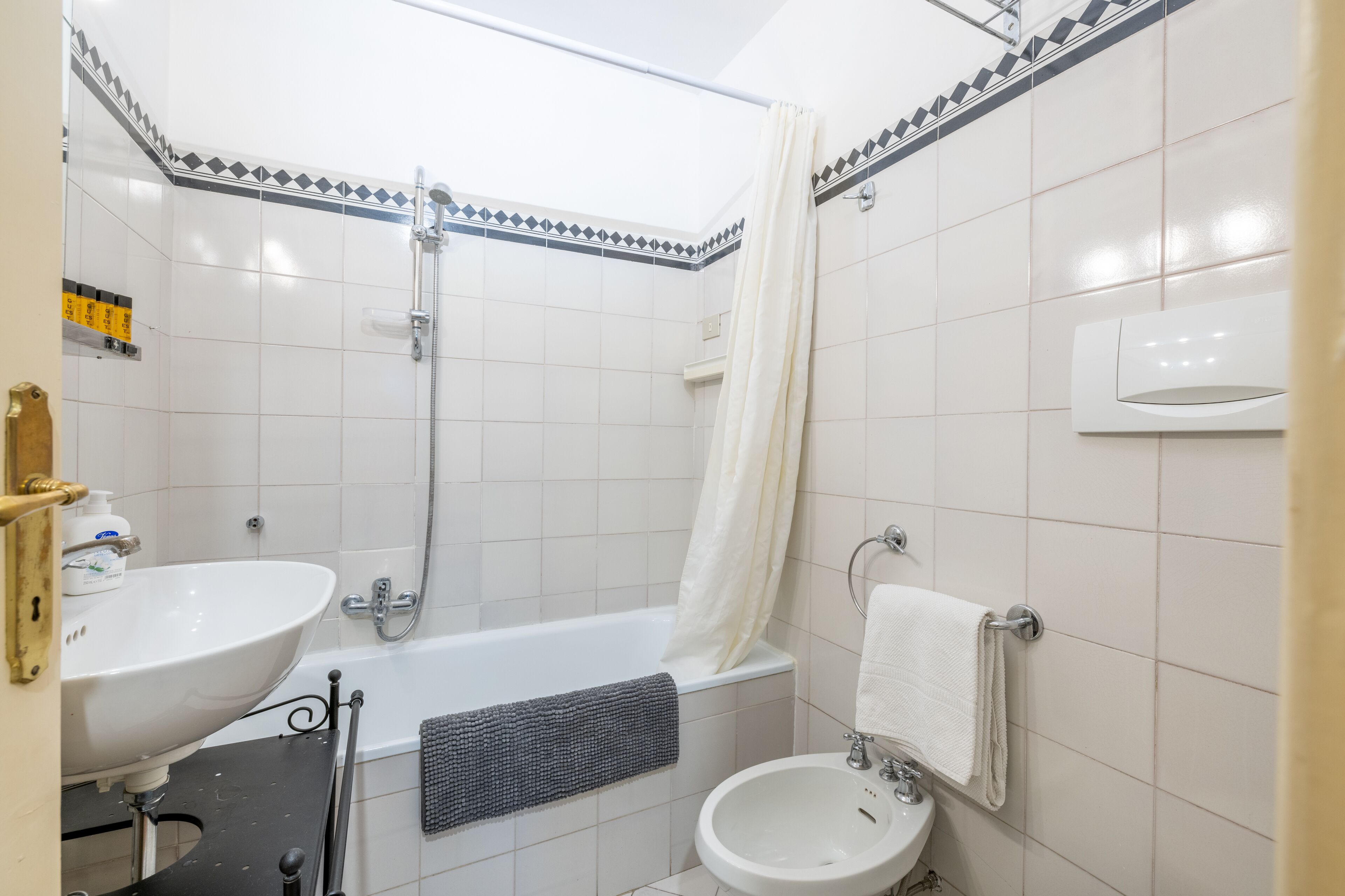 A bathroom with a bathtub, a sink, and a toilet.