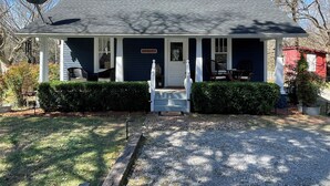 A two-story house with a porch, a satellite dish, and a mailbox. - Peaceful Cottage Retreat Near Nashville! (Ashland City)