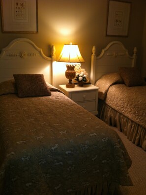 Classic bedroom with a large bed, nightstands, and decorative lamps.
