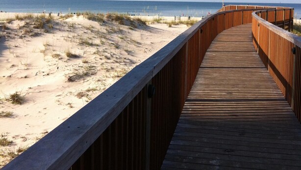 A wooden boardwalk leading to a beach with sand dunes and the ocean in the background. - Beach Club 3bd, 3ba. First floor on the beach. Super Special rate for Aug & Sept (Gulf Shores)