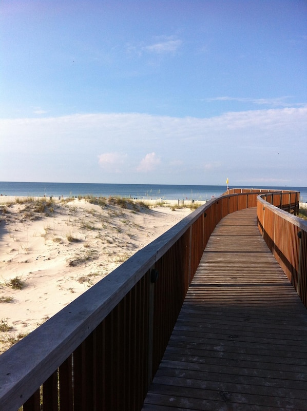 Walk along the boardwalk to the pristine beach.