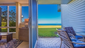 A patio with a view of the beach, a table with chairs, and a decorative lamp. - 180 degree Ocean Front Unobstructed View. Sleeps 8
New appliances. (Princeville)