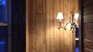 A wooden interior with a hanging lamp and a window. - Secluded Lookout Cabin- Fishing, ATV Trails, Canoe, Kayak & Campfires. (Shevlin)