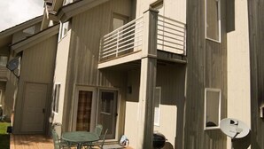A two-story building with a balcony, a deck with outdoor furniture, and satellite dishes. - 4 Br 3.5 baths Towne Home Driggs Idaho. Close to skiing, Jackson Hole, GTNP, YNP (Driggs)