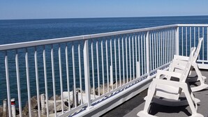 A balcony with white railings overlooking the sea. - Waterfront Cottage on Lake Erie (Huron)