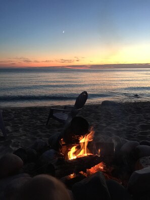 Relax by the ocean with a warm fire and comfortable seating.