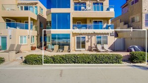 A multi-story hotel with balconies, a pool area, and a beach view. - 50' of Ocean Front * Exclusive Ground Level Patio * AC (San Diego)