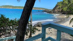 A beach with clear blue water, a sandy shore, and a view of the sea. - The Beach House on St. Thomas with Secluded Sand Beach (St. Thomas)