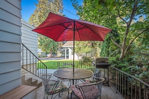 Enjoy al fresco dining on the patio with a round table and comfortable seating for four.