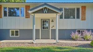 A two-story house with a front porch, a door, and a small window. - Beautiful and modern 3 bedroom, 1 bath Duplex.  Sleeps 6 (Chaffee)