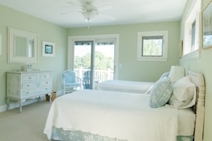 A bedroom with a bed, dresser, chair, and a ceiling fan. - Rent Two Suites On A Beautiful Five Acre Estate (Leland)