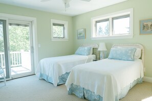 A room with two beds, a ceiling fan, and a view of the outdoors. - Rent Two Suites On A Beautiful Five Acre Estate (Leland)