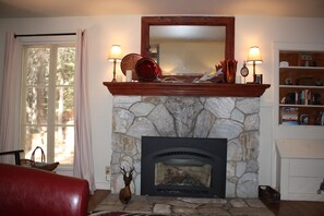 A stone fireplace with a mantel, a mirror above it, and two lamps on either side. - Clover Cabin In The Sequoia National Forest, not near the National Park (Camp Nelson)