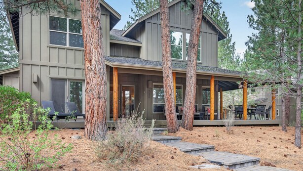 A two-story house with a covered porch and a patio area. - Bend Getaway in RiverWild-Walk to Deschutes River and Old Mill District (Bend)