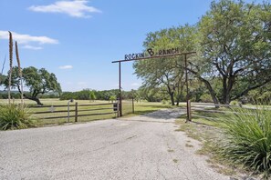 A gated entrance to a ranch with a sign reading 'Rockin' Ranch.'
