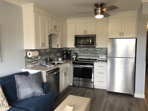 Brand new kitchen with quartz countertops, stainless steel appliances