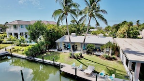 A waterfront property with a dock, lounge chairs, and a pool. - Wonderful Canal Front Condo! See Manatees Right From Your Doorstep!Cabana #10 (Longboat Key)