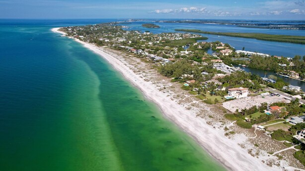 An aerial view of a coastal area with a beach, residential buildings, and a marina. - Wonderful Canal Front Condo! See Manatees Right From Your Doorstep!Cabana #10 (Longboat Key)
