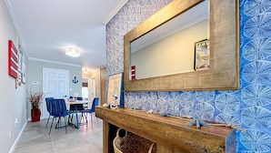 A hallway with a wooden bench, a woven basket, and a mirror above it. - Wonderful Canal Front Condo! See Manatees Right From Your Doorstep!Cabana #10 (Longboat Key)