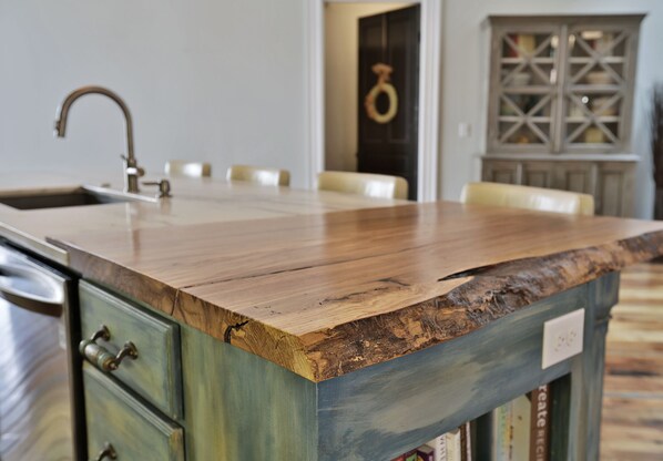 A kitchen with a wooden countertop, a sink, and a cabinet with a decorative door. - Urban Loft 5,000 SqFt. Sleeps 17 Next to Frankfort Distilleries,PERFECT LOCATION (Shelbyville)