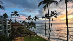 A resort with a swimming pool, palm trees, and ocean views. - Direct Oceanfront Condo with Amazing Island Views!! (Lahaina)