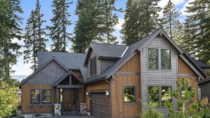 A two-story house with a garage, large windows, and a stone foundation. - Central Location w/ Suncadia Pool Access (Cle Elum)
