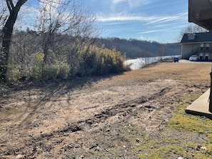 A dirt path leading to a house with a garage and a vehicle parked outside. - Waterfront Walk In (Branson)