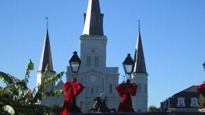 A church with three spires and a clock tower.
