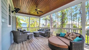 A covered porch with wicker furniture, a ceiling fan, and a view of trees. - 2 Master Suites, 4 Bedroom,  Five ★ Home, Gourmet Kitchen - short walk to beach (Santa Rosa Beach)