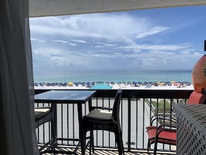 Enjoy the ocean view from this balcony with a seating area and access to the beach.