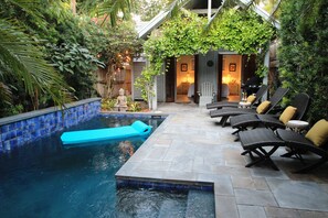 A private pool area with lounge chairs and a small Buddha statue. - Key West Oasis, Seperate Cottage, Very Private Pool and Back Yard (Key West)