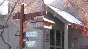 A residential building with a sign indicating resident parking only.
