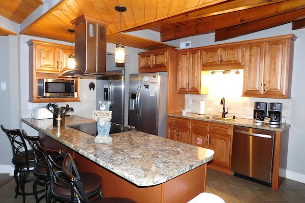 Updated kitchen with 2 refrigerator/freezers, pantry and bar/counter