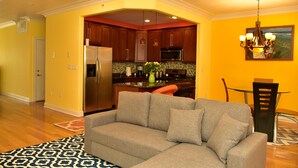 A modern kitchen with wooden cabinets, a stainless steel refrigerator, and a microwave. - Beach Front,Ideal for family and couples,beautiful place for sunset lovers!!!!!! (Arverne)